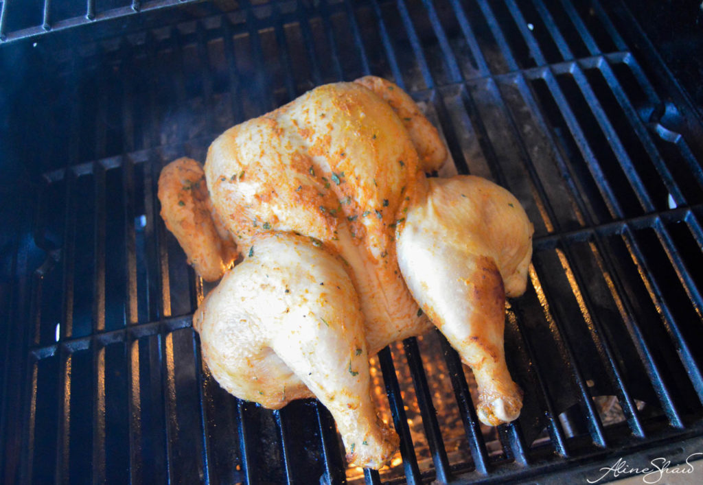 A butterflied chicken on the grill