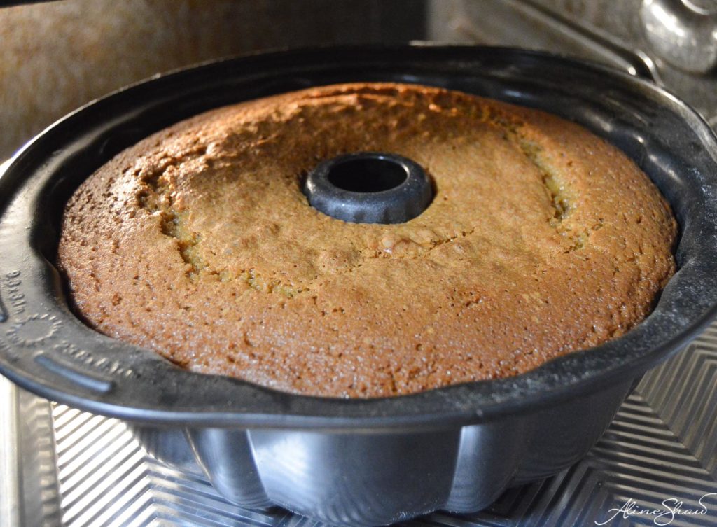 A baked bundt cake still in the pan