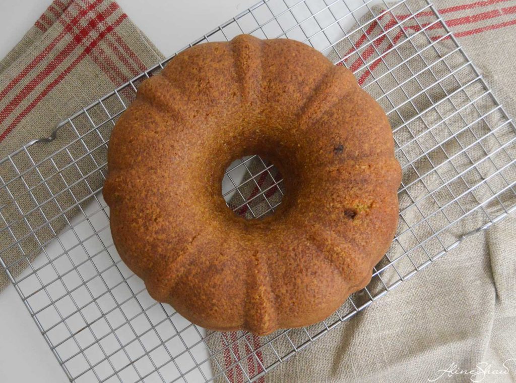 A bundt cake cools on a wire rack