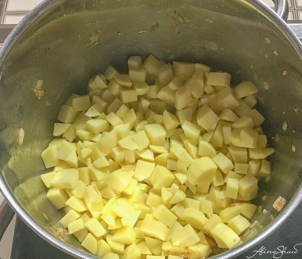 Diced potatoes in a large soup pan before cooking
