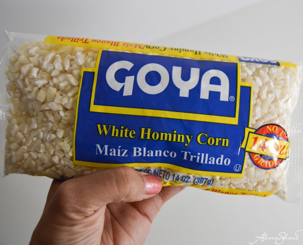 A hand holds a bag of Goyawhite hominy corn