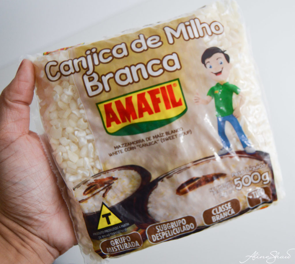 A hand holds a package of Amafil canjica de milho braca hominy