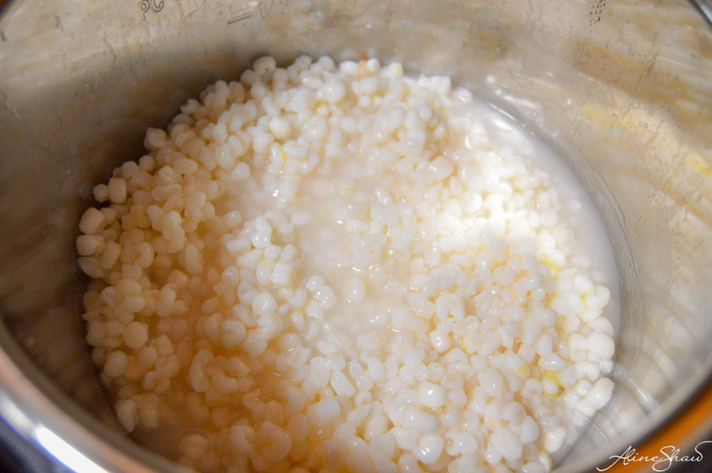 Cooked white hominy corn in the pressure cooker