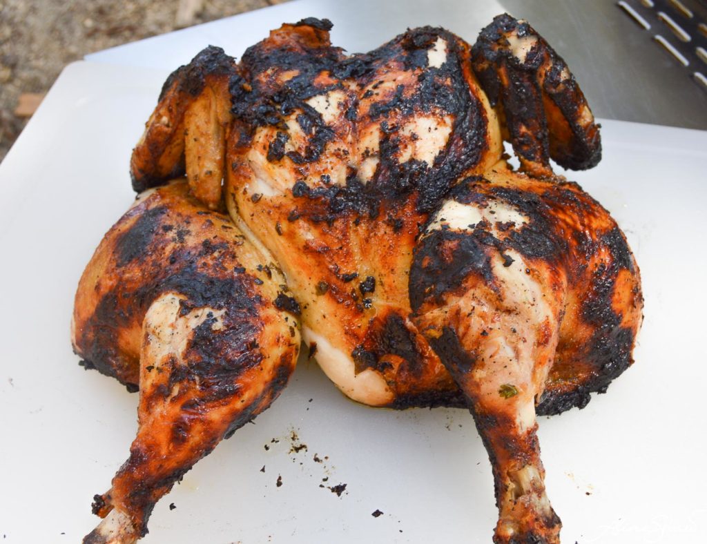 Chargrilled spatchcock chicken on a cutting board