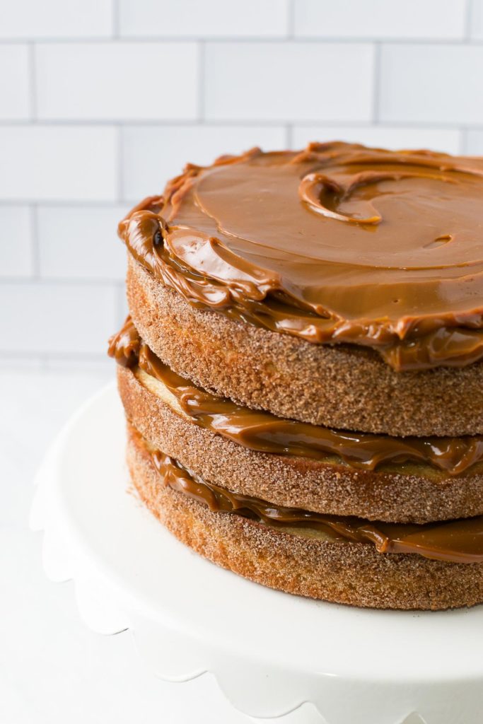 Brazilian Churro Cake filled and topped with dulce de leche