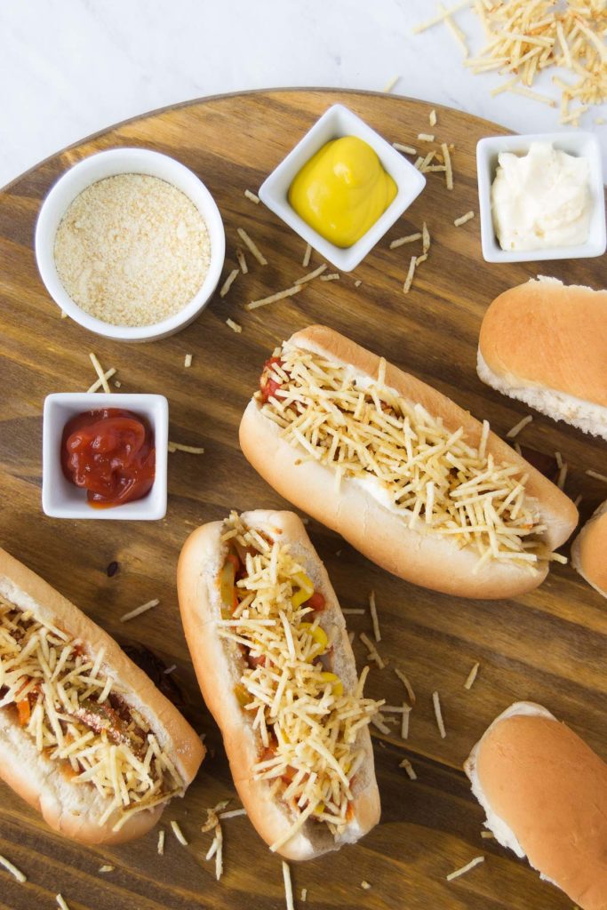 Brazilian Hot Dogs spread with sauce and toppings