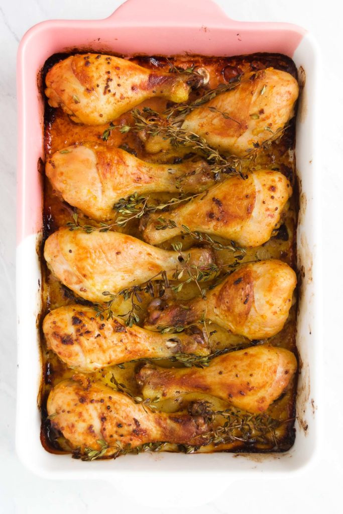 Baked Chicken Legs in a baking dish straight out of the oven