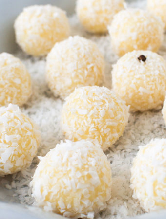 Close up of Brazilian coconut balls on a platter and garnished with whole cloves