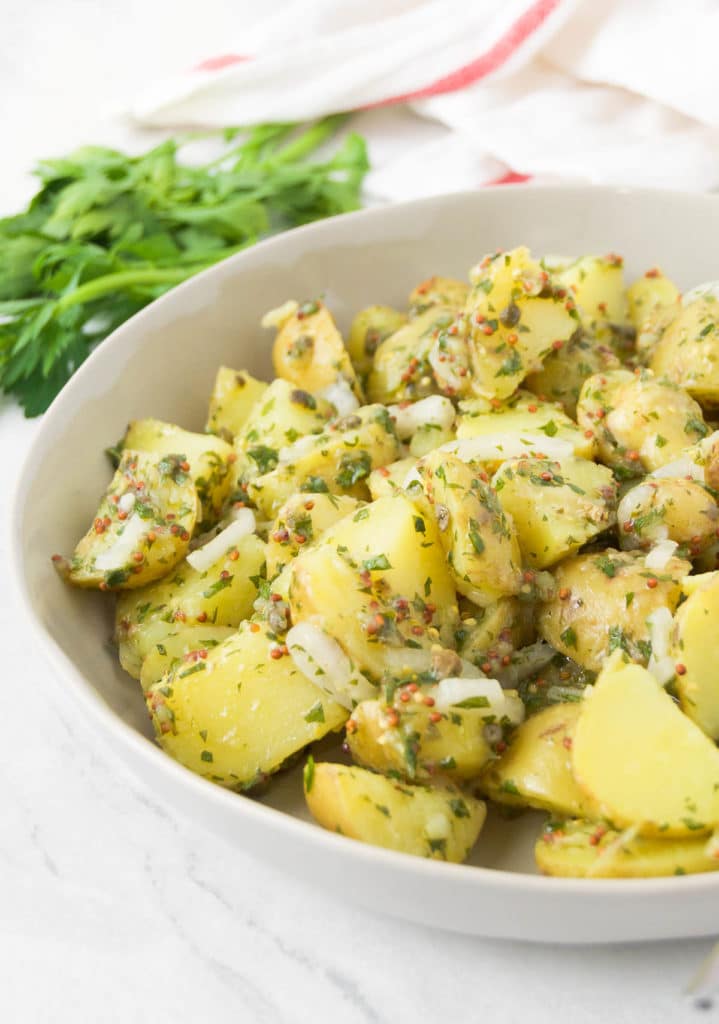 Close up of the mustard potato salad in a white bowl