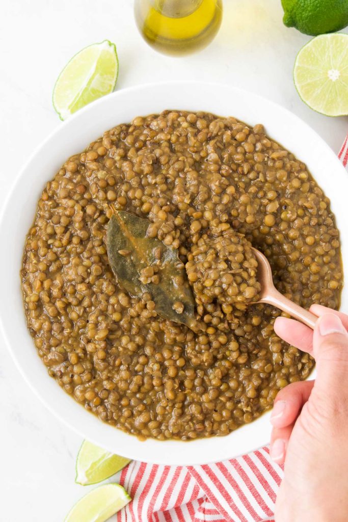 A person scoops a spoon of Instant Pot lentils