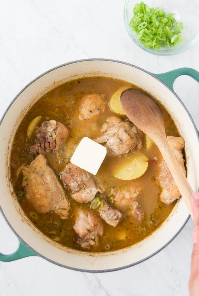 A pat of butter sits on top of Brazilian Chicken Stew