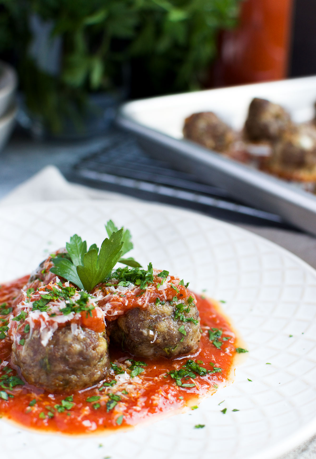 Ground beef and sausage meatballs in tomato sauce with fresh basil