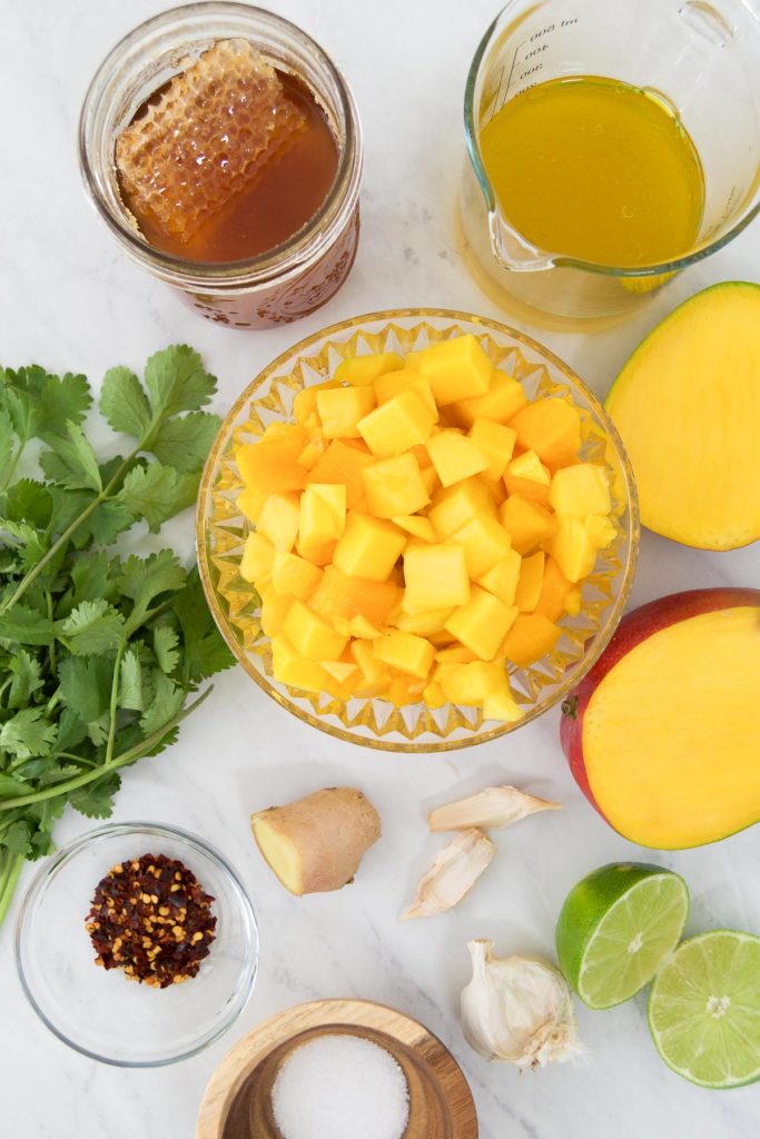 Ingredients to make mango dressing in bowls