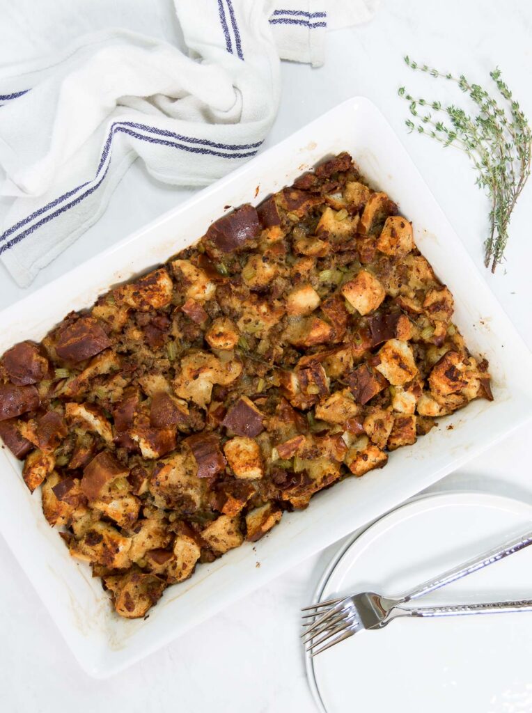 A casserole dish of Beer Pretzel Stuffing on a table top