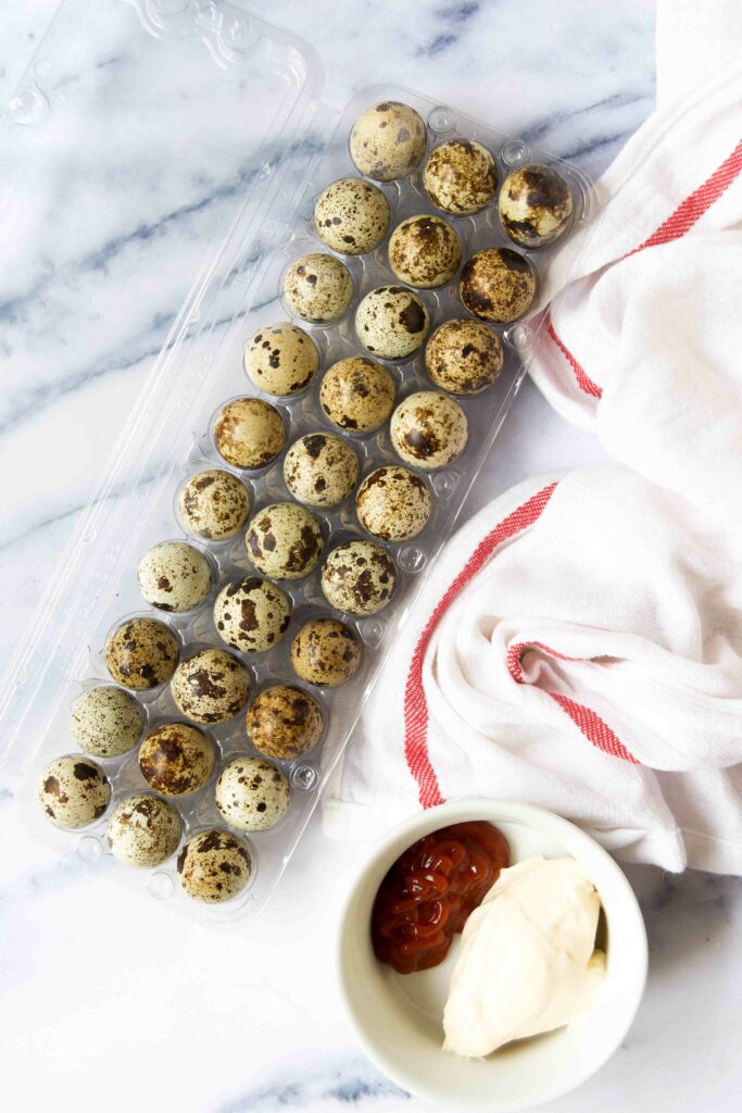 Quail eggs in a plastic container on marble