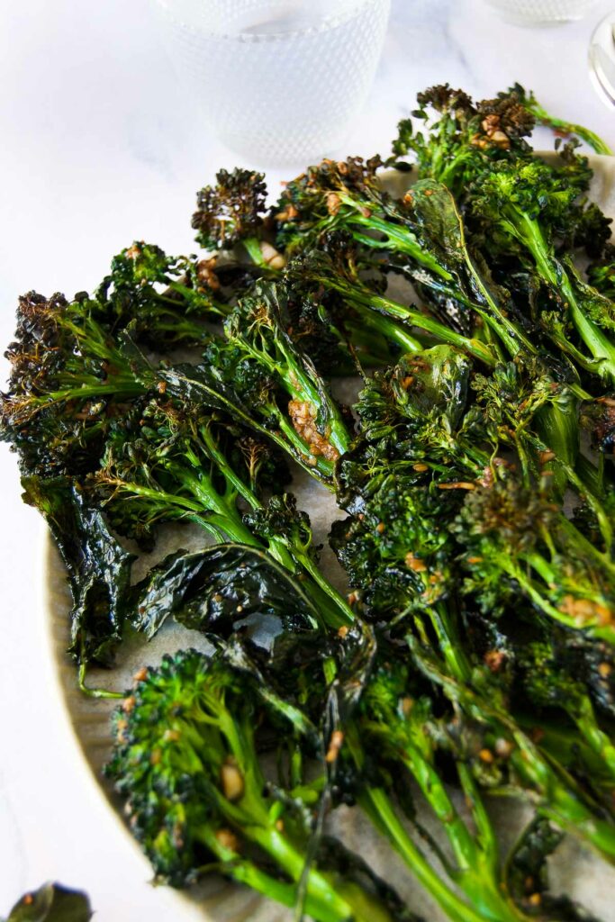 close up of crispy broccolini after cooking on a platter